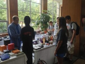 Students survey the headphones on display