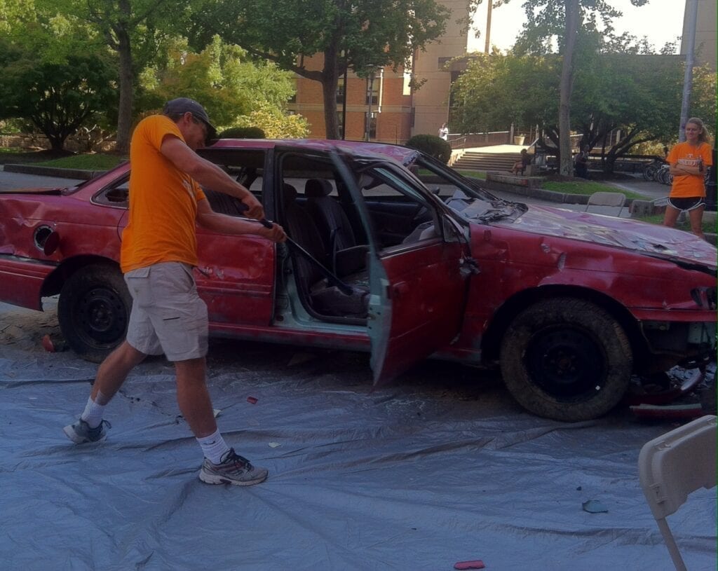 A UT student doing his worst on the car.
