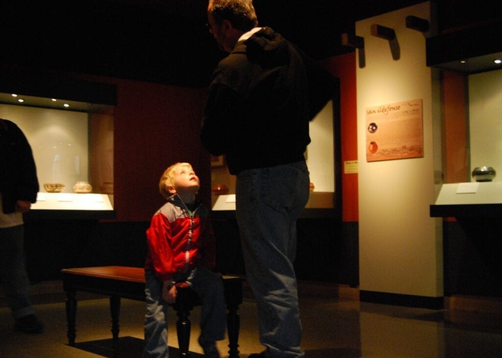 A son waits for his father at the family activity day. 