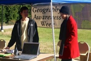 Vice President of Club Geography, Michael Schilling, works the booth with Dr. Sally Horn on Tuesday.