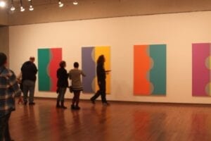 Students look at the Color Refined exhibit located in the Ewing Gallery in the Art & Architecture building. 