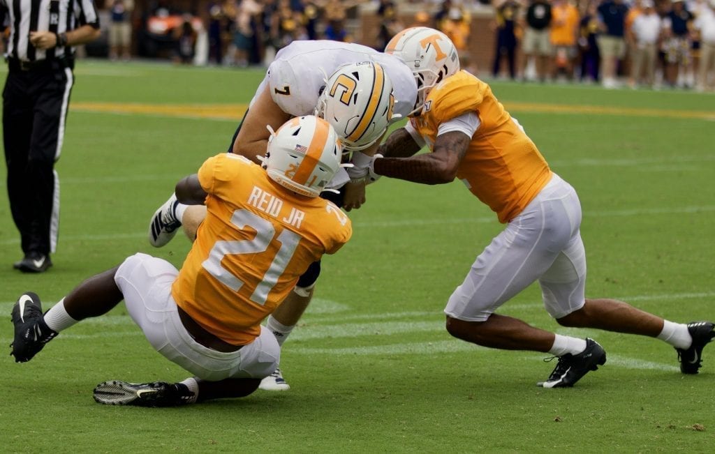 Tennessee linebacker Shanon Reid #21 and defensive back Alontae Taylor #2 wrap up Chattanooga quarterback Nick Tiano #7 in Neyland Stadium on Sept. 14, 2019 in Knoxville, Tennessee. Photo/ Ben Gleason
