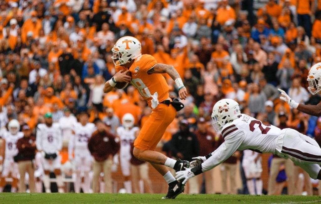 Tennessee quarterback Brian Maurer (18) runs past a Mississippi State defender on Oct. 12, 2019 in Knoxville, Tennessee. Photo/ Ben Gleason